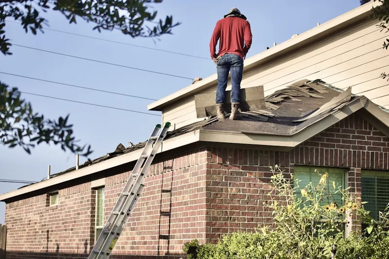Professional roofer working on a residential roof in San Fernando